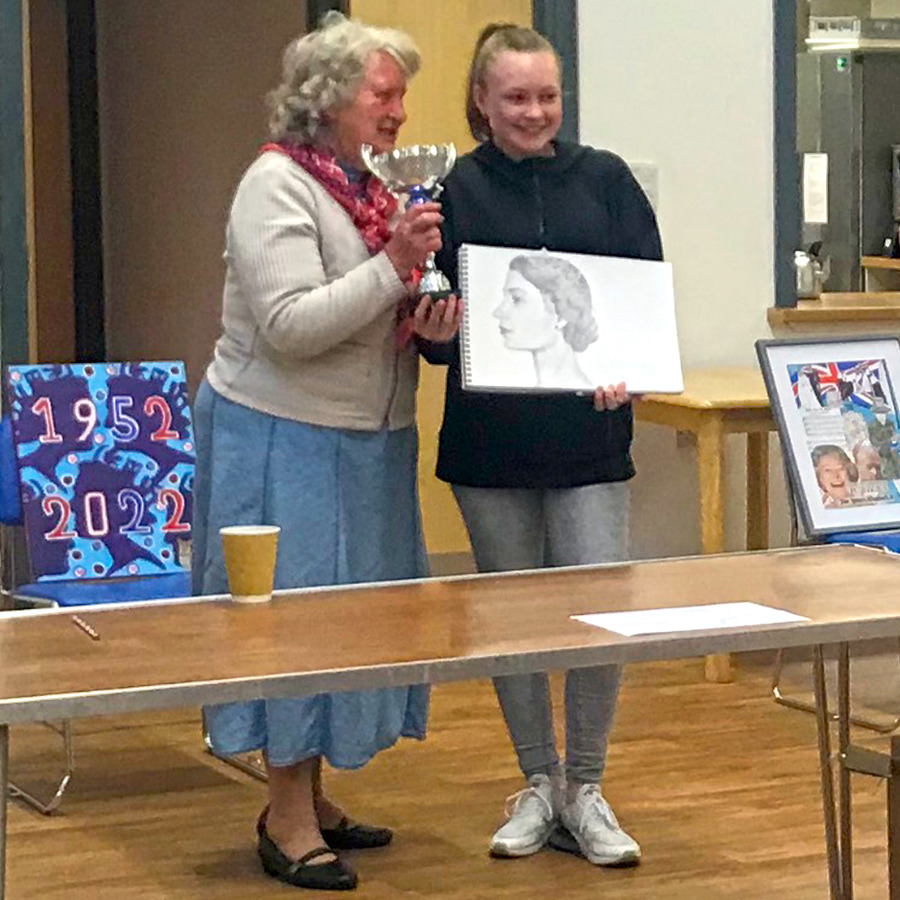 Margaret Lyntott, the Life President, presenting runner up award for HM Queen portrait to Lucy (aged 14)